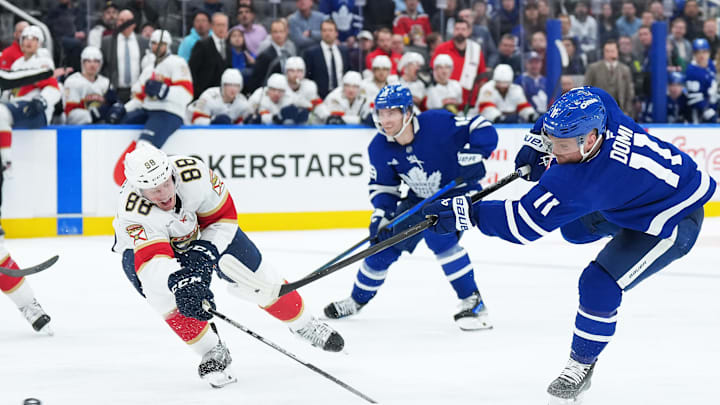 Mar 13, 2025; Toronto, Ontario, CAN; Toronto Maple Leafs center Max Domi (11) shoots the puck past Florida Panthers defenseman Nate Schmidt (88) scoring a goal during the third period at Scotiabank Arena. Mandatory Credit: Nick Turchiaro-Imagn Images
