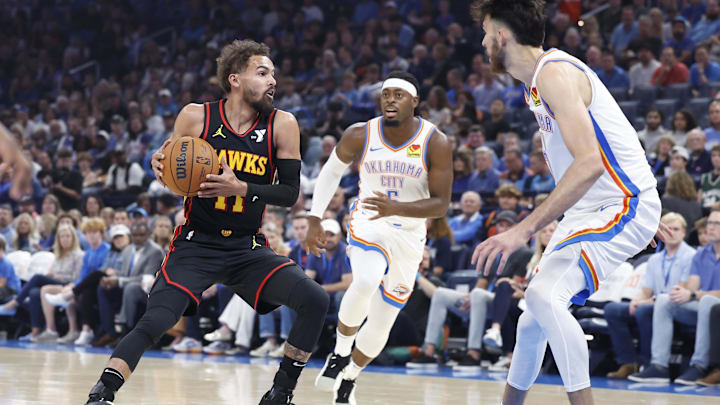 Oct 27, 2024; Oklahoma City, Oklahoma, USA; Atlanta Hawks guard Trae Young (11) drives down the court against Oklahoma City Thunder forward Chet Holmgren (7) and guard Luguentz Dort (5) during the first quarter at Paycom Center. Mandatory Credit: Alonzo Adams-Imagn Images