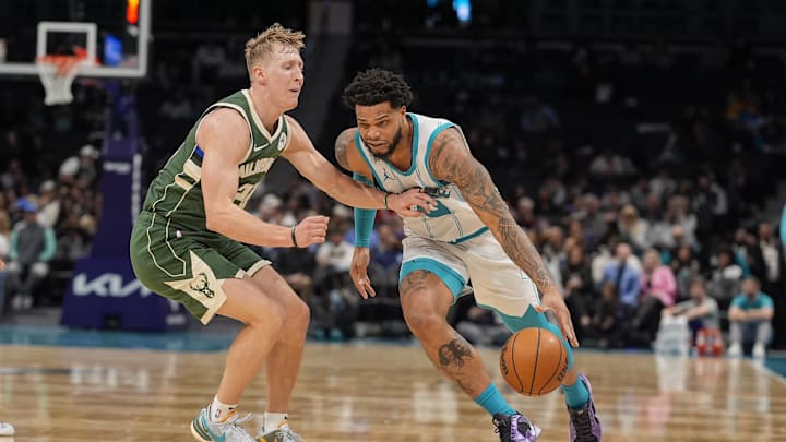 Feb 5, 2025; Charlotte, North Carolina, USA; Charlotte Hornets forward Miles Bridges (0) drives to the basket against Milwaukee Bucks guard AJ Green (20) during the second half at Spectrum Center. Mandatory Credit: Jim Dedmon-Imagn Images