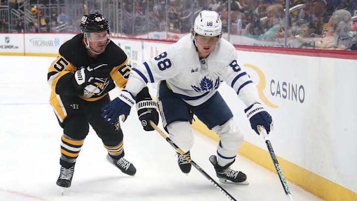 Mar 2, 2025; Pittsburgh, Pennsylvania, USA;  Toronto Maple Leafs right wing William Nylander (88) moves the puck against Pittsburgh Penguins center Noel Acciari (55) during the third period at PPG Paints Arena. Mandatory Credit: Charles LeClaire-Imagn Images