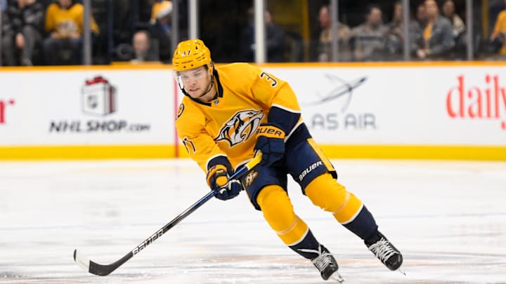 Dec 19, 2024; Nashville, Tennessee, USA;  Nashville Predators defenseman Nick Blankenburg (37) skates with the puck against the Pittsburgh Penguins during the first period at Bridgestone Arena. Mandatory Credit: Steve Roberts-Imagn Images