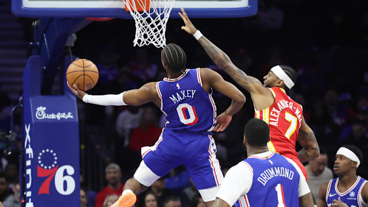 Feb 19, 2026; Philadelphia, Pennsylvania, USA; Philadelphia 76ers guard Tyrese Maxey (0) scores past Atlanta Hawks guard Nickeil Alexander-Walker (7) during the first quarter at Xfinity Mobile Arena. Mandatory Credit: Bill Streicher-Imagn Images