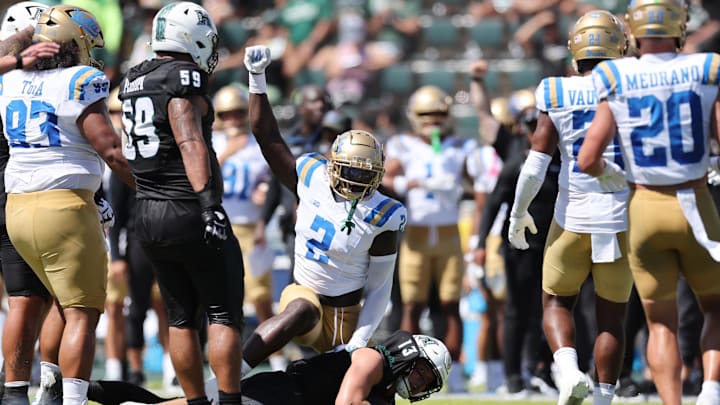 Aug 31, 2024; Honolulu, Hawaii, USA; UCLA Bruins linebacker Oluwafemi Oladejo (2) reacts after tackling Hawaii Rainbow Warriors quarterback Brayden Schager (13) during the 2nd quarter of an NCAA college football game at the Clarence T.C. Ching Athletics Complex. Mandatory Credit: Marco Garcia-Imagn Images Aug 31, 2024; Honolulu, Hawaii, USA; UCLA Bruins linebacker Oluwafemi Oladejo (2) reacts after tackling Hawaii Rainbow Warriors quarterback Brayden Schager (13) during the 2nd quarter of an NCAA college football game at the Clarence T.C. Ching Athletics Complex. Mandatory Credit: Marco Garcia-Imagn Images