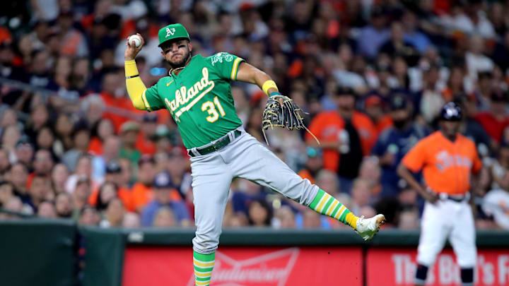 Sep 16, 2022; Houston, Texas, USA; Oakland Athletics third baseman Vimael Machin (31) throws a fielded ball to first base for an out against the Houston Astros during the second inning at Minute Maid Park.