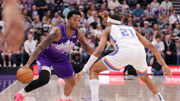 Apr 11, 2025; Salt Lake City, Utah, USA;  Utah Jazz forward Brice Sensabaugh (28) tries to dribble past Oklahoma City Thunder guard Aaron Wiggins (21) during the second half at Delta Center. Mandatory Credit: Chris Nicoll-Imagn Images