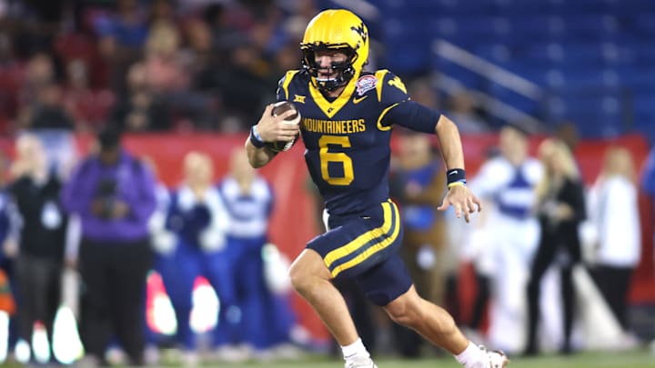 Dec 17, 2024; Frisco, TX, USA; West Virginia Mountaineers quarterback Garrett Greene (6) runs for a touchdown against the Memphis Tigers in the second quarter at Toyota Stadium. Mandatory Credit: Tim Heitman-Imagn Images Dec 17, 2024; Frisco, TX, USA; West Virginia Mountaineers quarterback Garrett Greene (6) runs for a touchdown against the Memphis Tigers in the second quarter at Toyota Stadium. Mandatory Credit: Tim Heitman-Imagn Images