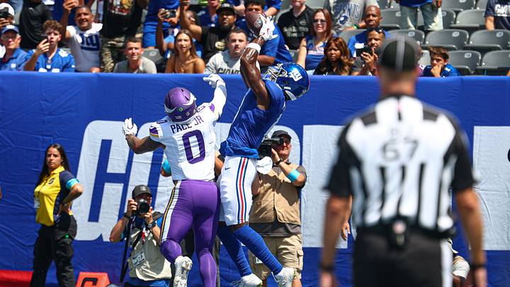 Aug 15, 2026; East Rutherford, New Jersey, USA;  New York Giants wide receiver Malachi Fields (0) catches a touchdown pass as Minnesota Vikings linebacker Ivan Pace Jr. (0) defends during the first half at MetLife Stadium. Mandatory Credit: Vincent Carchietta-Imagn Images