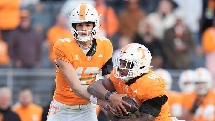 Tennessee quarterback George MacIntyre (12) hands the ball off to Tennessee running back DeSean Bishop (18) during a game between Tennessee and Alabama in Neyland Stadium in Knoxville, Tenn., Oct. 17, 2026. Tennessee quarterback George MacIntyre (12) hands the ball off to Tennessee running back DeSean Bishop (18) during a game between Tennessee and Alabama in Neyland Stadium in Knoxville, Tenn., Oct. 17, 2026.