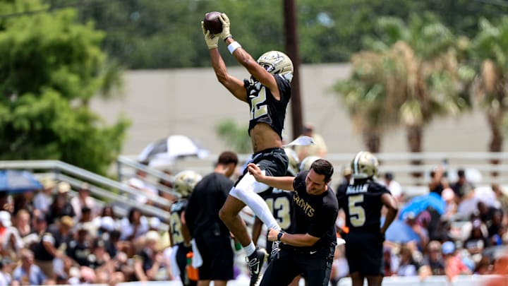 Wide receiver Chris Olave catches a pass during New Orleans Saints Mandatory Minicamp