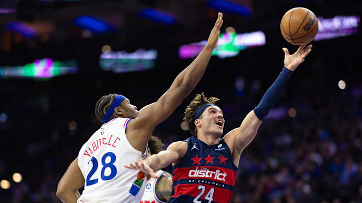 Jan 8, 2025; Philadelphia, Pennsylvania, USA; Washington Wizards forward Corey Kispert (24) drives for a shot past Philadelphia 76ers forward Guerschon Yabusele (28)during the second quarter at Wells Fargo Center. Mandatory Credit: Bill Streicher-Imagn Images
