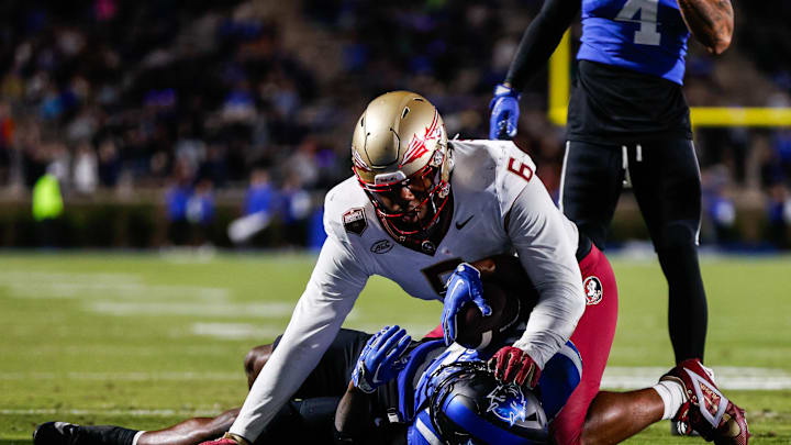 Oct 18, 2024; Durham, North Carolina, USA; Duke Blue Devils quarterback Maalik Murphy (6) attempts to run the ball to the end zone but is tacked by Florida State Seminoles defensive lineman Darrell Jackson Jr. (6) during the first half of the game at Wallace Wade Stadium. Mandatory Credit: Jaylynn Nash-Imagn Images