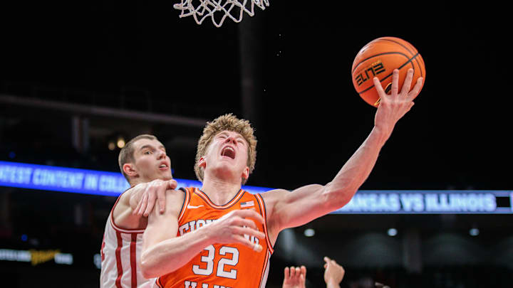 Illinois Fighting Illini guard Kasparas Jakucionis (32) drives to the basket during the second half against Zvonimir Ivisic of the Arkansas Razorbacks at T-Mobile Center on Thanksgiving Day. Illinois jumped to an 11-0 start and whipped the Hogs 90-77. Jakucionis scored 23 points to lead Illinois.