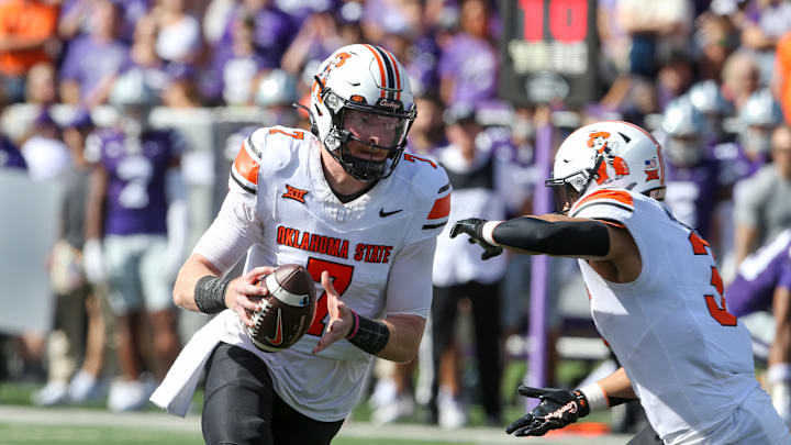 Sep 28, 2024; Manhattan, Kansas, USA; Oklahoma State Cowboys quarterback Alan Bowman (7) fakes a handoff to running back Sesi Vailahi (3) against the Kansas State Wildcats during the first quarter at Bill Snyder Family Football Stadium. Mandatory Credit: Scott Sewell-Imagn Images Sep 28, 2024; Manhattan, Kansas, USA; Oklahoma State Cowboys quarterback Alan Bowman (7) fakes a handoff to running back Sesi Vailahi (3) against the Kansas State Wildcats during the first quarter at Bill Snyder Family Football Stadium. Mandatory Credit: Scott Sewell-Imagn Images
