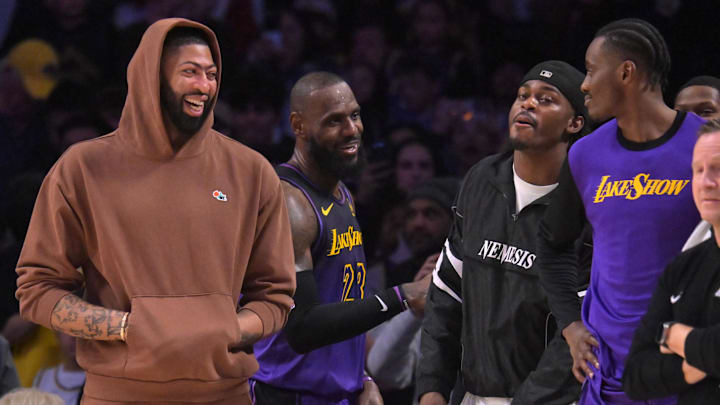 Jan 2, 2025; Los Angeles, California, USA;   Los Angeles Lakers forward Anthony Davis (3), forward LeBron James (23), forward Jarred Vanderbilt (2) and center Christian Koloko (10) on the bench in the fourth quarter against the Portland Trail Blazers at Crypto.com Arena. Mandatory Credit: Jayne Kamin-Oncea-Imagn Images
