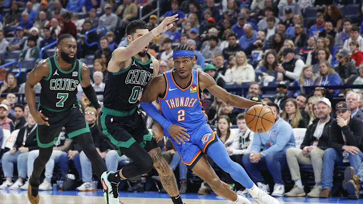 Jan 2, 2024; Oklahoma City, Oklahoma, USA; Oklahoma City Thunder guard Shai Gilgeous-Alexander (2) drives to the basket against Boston Celtics forward Jayson Tatum (0) during the second quarter at Paycom Center. Mandatory Credit: Alonzo Adams-Imagn Images