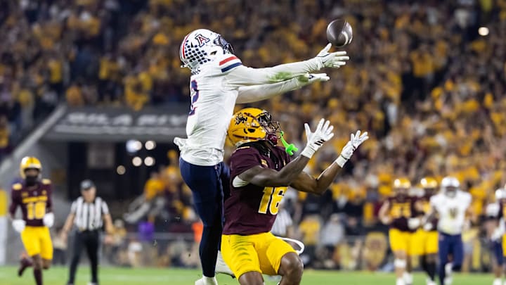 Nov 28, 2025; Tempe, Arizona, USA; Arizona Wildcats defensive back Treydan Stukes (2) intercepts the ball against Arizona State Sun Devils wide receiver Jaren Hamilton (16) in the second half during the 99th Territorial Cup at Mountain America Stadium. Mandatory Credit: Mark J. Rebilas-Imagn Images