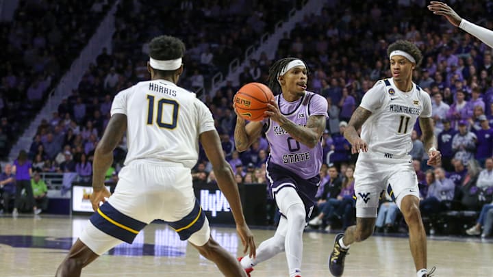 Jan 25, 2025; Manhattan, Kansas, USA; Kansas State Wildcats guard Dug McDaniel (0) dribbles between West Virginia Mountaineers guard Jonathan Powell (11) and guard Sencire Harris (10) during the first half at Bramlage Coliseum. Mandatory Credit: Scott Sewell-Imagn Images