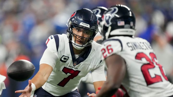Houston Texans quarterback C.J. Stroud (7) tosses the ball to Houston Texans running back Devin Singletary (26) on Saturday, Jan. 6, 2024, during a game against the Houston Texans at Lucas Oil Stadium in Indianapolis.