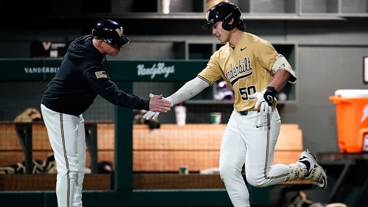 Vanderbilt catcher Aukai Kea (50) celebrates his two run home run against Eastern Michigan with coach Tim Corbin during the sixth inning at Hawkins Field in Nashville, Tenn., Wednesday, Feb. 18, 2026.