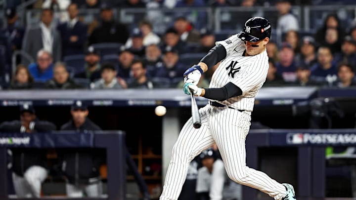 Oct 14, 2024; Bronx, New York, USA; New York Yankees first base Anthony Rizzo (48) hits a single during the second inning against the Cleveland Guardians in game one of the ALCS for the 2024 MLB Playoffs at Yankee Stadium. Mandatory Credit: Wendell Cruz-Imagn Images