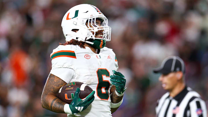 Miami Hurricanes running back Damien Martinez (6) scores a touchdown against the South Florida Bulls in the third quarter at Raymond James Stadium. Miami Hurricanes running back Damien Martinez (6) scores a touchdown against the South Florida Bulls in the third quarter at Raymond James Stadium.