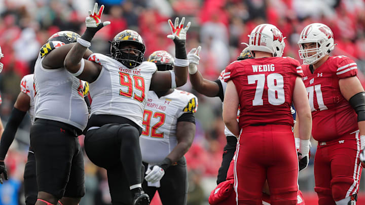Maryland defensive lineman Tommy Akingbesote (99) celebrates after sacking Wisconsin quarterback Graham Mertz on Saturday at Camp Randall Stadium in Madison, Wis. Maryland defensive lineman Tommy Akingbesote (99) celebrates after sacking Wisconsin quarterback Graham Mertz on Saturday at Camp Randall Stadium in Madison, Wis.