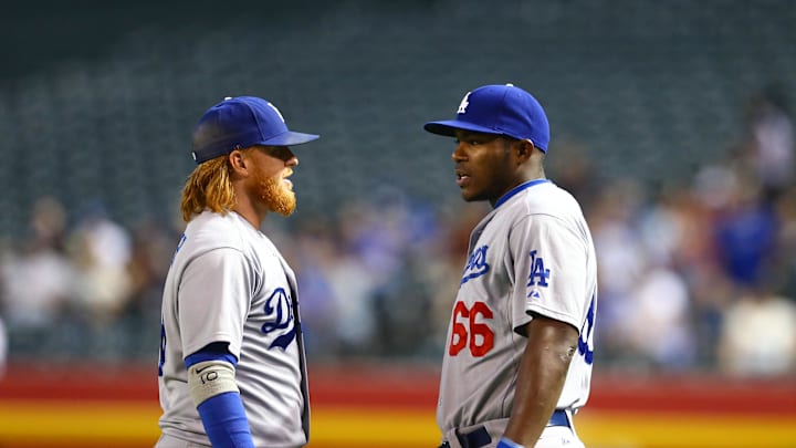 Aug 26, 2014; Phoenix, AZ, USA; Los Angeles Dodgers third baseman Justin Turner (left) talks with outfielder Yasiel Puig against the Arizona Diamondbacks at Chase Field. Mandatory Credit: Mark J. Rebilas-Imagn Images