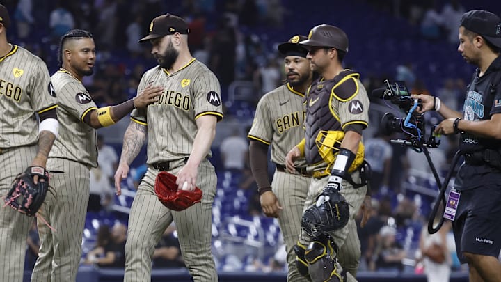 Aug 9, 2024; Miami, Florida, USA;  San Diego Padres designated hitter Luis Arraez (4) and relief pitcher Tanner Scott (66) celebrate their win against the Miami Marlins at loanDepot Park. Mandatory Credit: Rhona Wise-Imagn Images