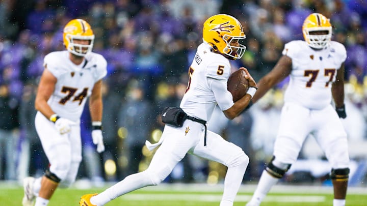 Nov 13, 2021; Seattle, Washington, USA; Arizona State Sun Devils quarterback Jayden Daniels (5) rushes against the Washington Huskies during the second quarter at Alaska Airlines Field at Husky Stadium. Mandatory Credit: Joe Nicholson-Imagn Images