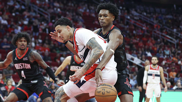 Mar 14, 2024; Houston, Texas, USA; Houston Rockets forward Amen Thompson (1) attempts to steal the ball from Washington Wizards forward Kyle Kuzma (33) during the third quarter at Toyota Center. Mandatory Credit: Troy Taormina-Imagn Images