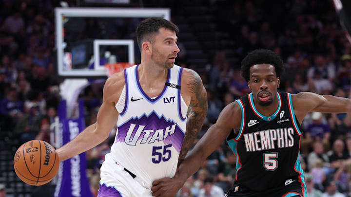 Apr 10, 2026; Salt Lake City, Utah, USA; Utah Jazz guard John Konchar (55) dribbles with the ball against Memphis Grizzlies forward Toby Okani (5) during the second half at Delta Center. Mandatory Credit: Rob Gray-Imagn Images