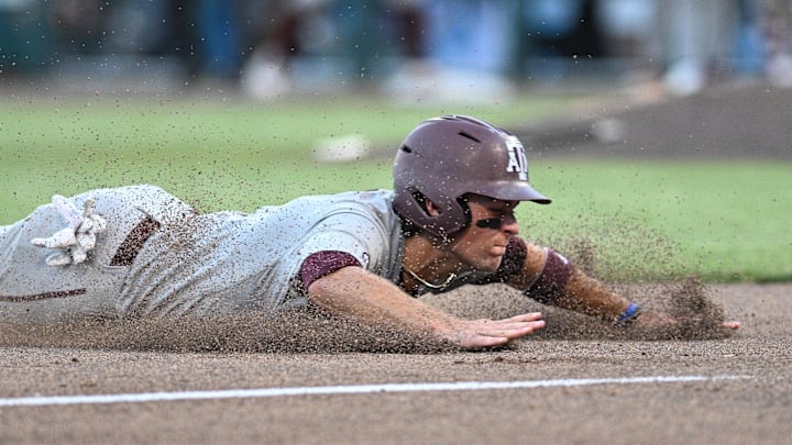 Jun 24, 2024; Omaha, NE, USA;  Texas A&M Aggies second baseman Kaeden Kent (3) slides into third base against the Tennessee Volunteers during the seventh inning at Charles Schwab Field Omaha. Mandatory Credit: Steven Branscombe-Imagn Images