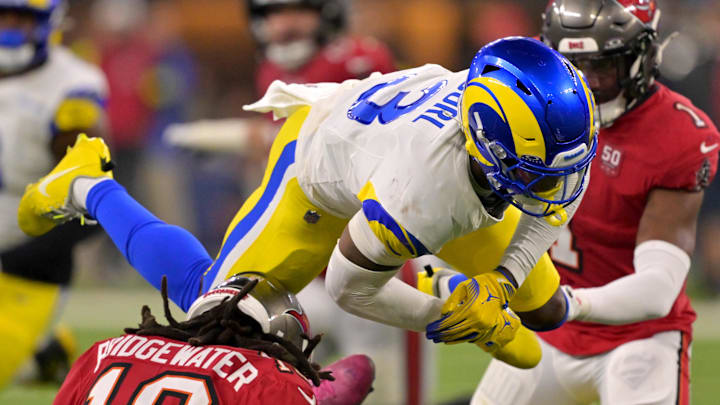 Los Angeles Rams safety Kam Curl (3) leaps over Tampa Bay Buccaneers quarterback Teddy Bridgewater (10) as he is sacked by linebacker Byron Young (0) in the second half at SoFi Stadium.