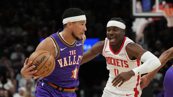 Phoenix Suns guard Devin Booker drives on Houston Rockets guard Aaron Holiday Phoenix Suns guard Devin Booker drives on Houston Rockets guard Aaron Holiday