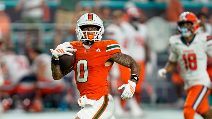 Nov 8, 2025; Miami Gardens, Florida, USA; Miami Hurricanes wide receiver Keelan Marion (0) catches a touchdown pass against the Syracuse Orange during the third quarter at Hard Rock Stadium. Mandatory Credit: Jeff Romance-Imagn Images Nov 8, 2025; Miami Gardens, Florida, USA; Miami Hurricanes wide receiver Keelan Marion (0) catches a touchdown pass against the Syracuse Orange during the third quarter at Hard Rock Stadium. Mandatory Credit: Jeff Romance-Imagn Images
