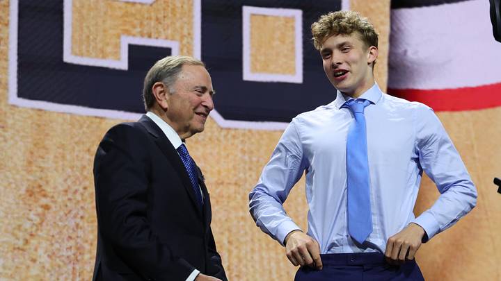 Jun 26, 2026; Buffalo, New York, USA; Juho Piiparinen talks to NHL commissioner Gary Bettman after being selected with the twenty ninth pick in the first round of the 2026 NHL Draft by the Vegas Golden Knights at KeyBank Center. Mandatory Credit: Timothy T. Ludwig-Imagn Images