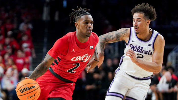Cincinnati Bearcats guard Jizzle James (2) attempts to drive past Kansas State Wildcats guard Max Jones (2) in the first half of a NCAA men’s basketball game between the Cincinnati Bearcats and Kansas State Wildcats, Wednesday, March 5, 2025, at Fifth Third Arena in Cincinnati.