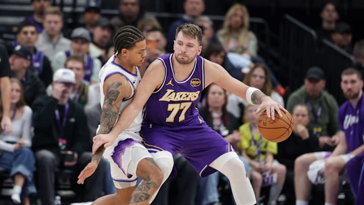 Dec 18, 2025; Salt Lake City, Utah, USA;  Los Angeles Lakers forward/guard Luka Doncic (77) tries to keep Utah Jazz guard Keyonte George (3) away from the ball during the second half at Delta Center. Mandatory Credit: Chris Nicoll-Imagn Images