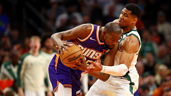 Mar 24, 2025; Phoenix, Arizona, USA; Phoenix Suns forward Kevin Durant (35) handles the ball against Milwaukee Bucks forward Giannis Antetokounmpo (34) during the fourth quarter at Footprint Center. Mandatory Credit: Mark J. Rebilas-Imagn Images