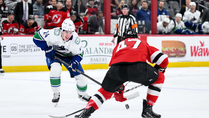 Dec 14, 2025; Newark, New Jersey, USA; Vancouver Canucks defenseman Zeev Buium (24) skates with the puck while defended by New Jersey Devils left wing Paul Cotter (47) during the first period at Prudential Center. Mandatory Credit: John Jones-Imagn Images Dec 14, 2025; Newark, New Jersey, USA; Vancouver Canucks defenseman Zeev Buium (24) skates with the puck while defended by New Jersey Devils left wing Paul Cotter (47) during the first period at Prudential Center. Mandatory Credit: John Jones-Imagn Images