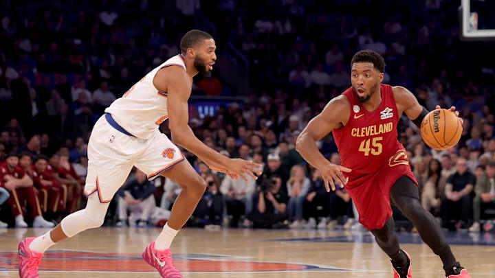 Oct 22, 2025; New York, New York, USA; Cleveland Cavaliers guard Donovan Mitchell (45) drives to the basket against New York Knicks guard Mikal Bridges (25) during the first quarter at Madison Square Garden. Mandatory Credit: Brad Penner-Imagn Images