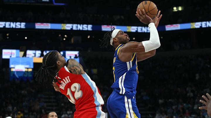 Apr 1, 2025; Memphis, Tennessee, USA; Golden State Warriors guard Buddy Hield (7) shoots as Memphis Grizzlies guard Ja Morant (12) defends during the fourth quarter at FedExForum. Mandatory Credit: Petre Thomas-Imagn Images