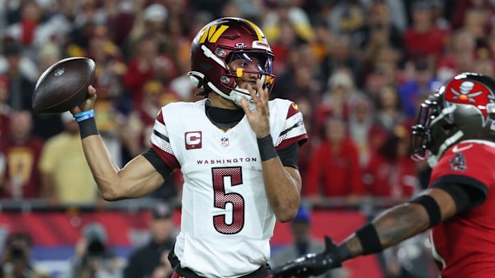 Jan 12, 2025; Tampa, Florida, USA; Washington Commanders quarterback Jayden Daniels (5) throws during the second quarter of a NFC wild card playoff against the Tampa Bay Buccaneers at Raymond James Stadium. Mandatory Credit: Kim Klement Neitzel-Imagn Images