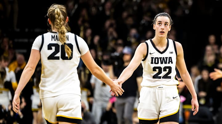 Iowa guard Kate Martin (20) gives teammate Caitlin Clark (22) a high-five during a NCAA Big Ten Conference women's basketball game against Michigan, Thursday, Feb. 15, 2024, at Carver-Hawkeye Arena in Iowa City, Iowa.