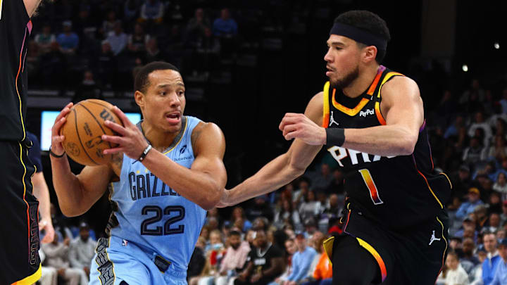 Memphis Grizzlies guard Desmond Bane drives to the basket as Phoenix Suns guard Devin Booker defends. Memphis Grizzlies guard Desmond Bane drives to the basket as Phoenix Suns guard Devin Booker defends.