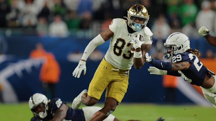 Jan 9, 2025; Miami, FL, USA; Notre Dame Fighting Irish wide receiver Jayden Thomas (83) runs pressured by Penn State Nittany Lions defensive tackle Zane Durant (28)  in the second half in the Orange Bowl at Hard Rock Stadium. Mandatory Credit: Sam Navarro-Imagn Images
