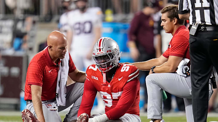 Trainers tend to Ohio State Buckeyes defensive end Kenyatta Jackson Jr. (97) during the NCAA football game against the Minnesota Golden Gophers at Ohio Stadium in Columbus on Oct. 4, 2025. Ohio State won 42-3.