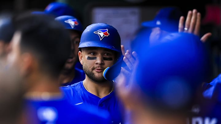Sep 2, 2025; Cincinnati, Ohio, USA; Toronto Blue Jays shortstop Bo Bichette (11) high fives teammates after hitting a three-run home run in the second inning against the Cincinnati Reds at Great American Ball Park. 
