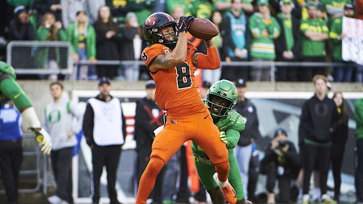 Nov 27, 2021; Eugene, Oregon, USA; Oregon State Beavers wide receiver Trevon Bradford (8) catches a touchdown pass during the second half against Oregon Ducks cornerback Dontae Manning (8) at Autzen Stadium. The Ducks won 38-29. Mandatory Credit: Troy Wayrynen-Imagn Images