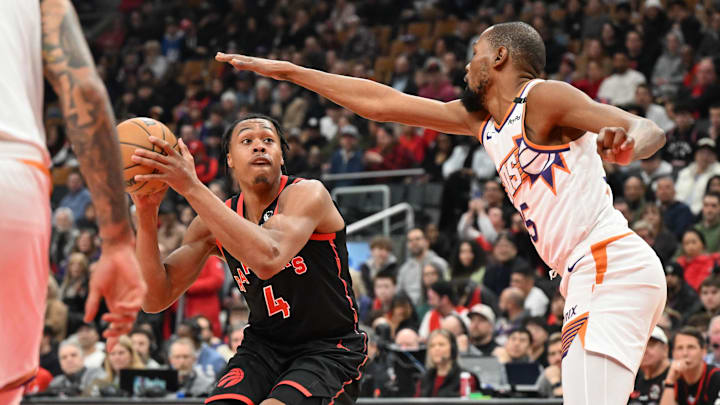 Feb 23, 2025; Toronto, Ontario, CAN;  Toronto Raptors forward Scottie Barnes (4) looks to take a shot as Phoenix Suns forward Kevin Durant (35) defends in the first half at Scotiabank Arena. Mandatory Credit: Dan Hamilton-Imagn Images
